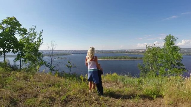 Woman with son on the rocky Bank of the Volga river. Slowmotion
