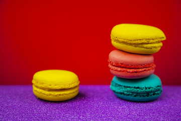 Fototapeta na wymiar Macaroon. Macaron on red background, different bright colors