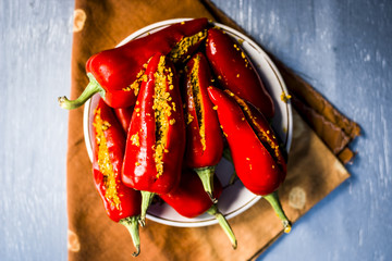 Red chilli pickle marinated in mustard seeds and mustard oil. Dark gothic style still life concept.