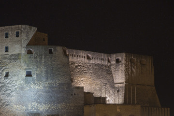Panorama of Castel dell'Ovo, a seaside castle in Naples, in Italy, with stars in background. The castle is located between the districts of San Ferdinando and Chiaia, facing Mergellina across the sea.
