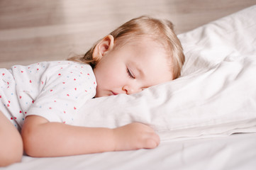 Little child sleeping on her tummy