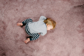 Toddler sleeping on the floor, top view