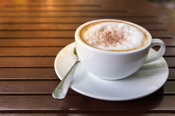 Cappuccino cup on wooden table