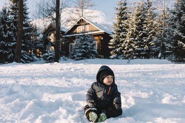 little boy in blue jacket  play with snow, winter holidays