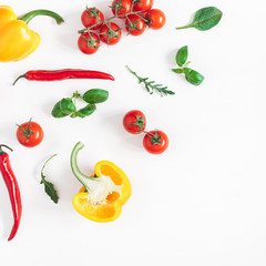 Vegetables on white background. Frame made of fresh vegetables. Tomatoes, peppers, green leaves. Flat lay, top view, copy space, square