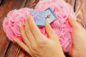 Girl opens a box with wedding ring, gift concept