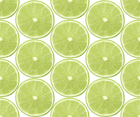 Fototapeta premium Seamless background with slices of lime fruits on white