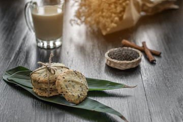 cookies with sesame seeds and glass of milk