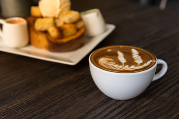 Hot coffee latte art cup  on wooden table