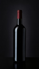 Fototapeta na wymiar Bottle of red wine on black background