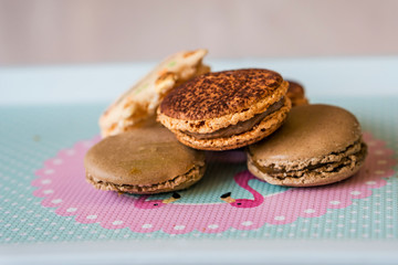 Close up of french macaroon with a taste of caramel and chocolate on a white background, shallow depth of focus. Concept Valentine day.