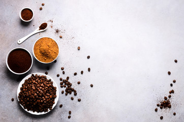 Ingredients for making caffeine drink - brown coconut sugar, coffee beans, ground and instant coffee on light concrete background, copy space, top view. Banner