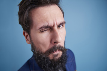 Handsome man with beard winking