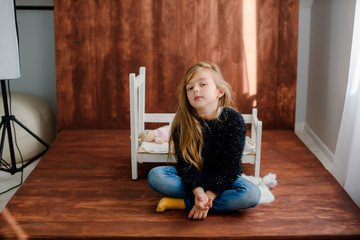 Portrait of sad little girl resting at home