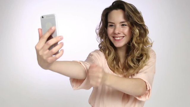 Woman sending air kiss for selfie