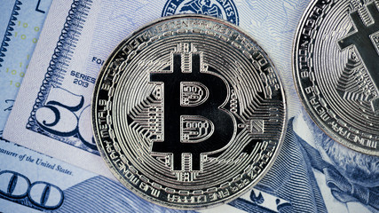 Close Up Of Bitcoin On US Dollar Banknote, Selective Focused. Electronic Money And Real Currency Exchange Concept.