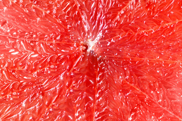 Grapefruit sliced half on grey background. Citrus fruit macro. Copy space, top view