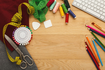 Workspace of fashion designer, top view