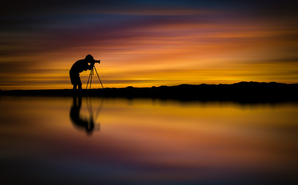 Silhouette Photographer take photo beautiful seascape at sunset in Thailand