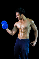 Asian man has muscle lift a blue dumbbell on black background, isolated with clipping path