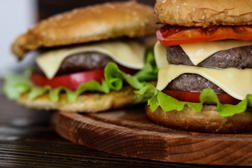 Homemade burger on wooden cutting board.