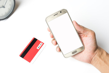 Hand holding a smartphone with blank screen on green blur background