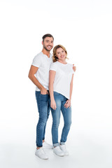 couple in casual clothing hugging and looking at camera, isolated on white