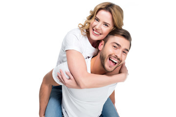 excited man piggybacking his smiling girlfriend, isolated on white