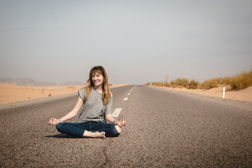 Fototapeta na wymiar Girl have fun on the road in a desert