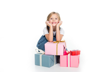 adorable cheerful child with gift boxes, isolated on white