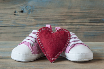 Baby shoes on wood background