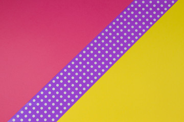 Abstract geometric yellow, purple and violet polka dot paper background.