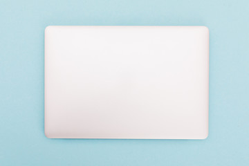 Top view of modern retina laptop, isolated on blue background.