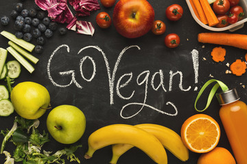 Lunch boxes filled with healthy food on black board