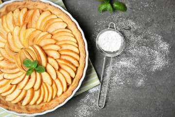 Homemade apple tart on grey background