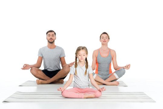 athletic family practicing yoga on mats together isolated on white