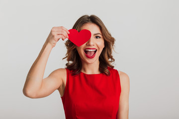 Portrait of a cheerful young woman dressed in red dress