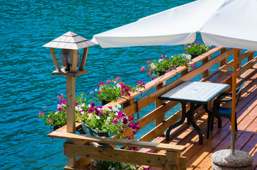 romantic terrace on Lake Alleghe, Belluno, Italy: an fascinating lake , in the geographic heart of...