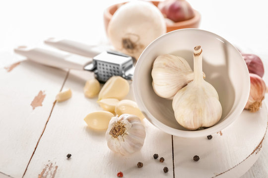 Fresh garlic on wooden board, closeup