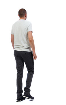 Back View Of Going  Handsome Man. Walking Young Guy . Rear View People Collection.  Backside View Of Person.  Isolated Over White Background. A Guy In A White T-shirt And Trousers Pass By.