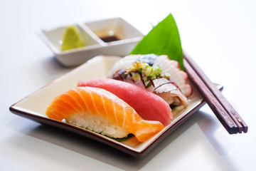 Sushi salmon & tuna sushi shrimp and wasabi on the white plate.selective focus
