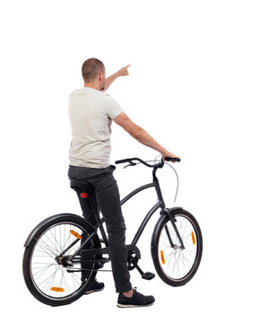 back view of pointing man with a bicycle.