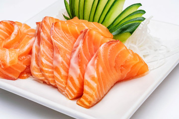 Sashimi, Salmon, Japanese food chopsticks and wasabi on the wood table
