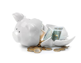 Broken piggy bank with money on white background
