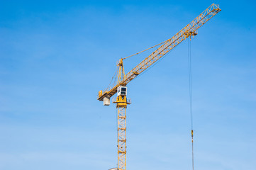 Building crane near a multi-storey residential building.