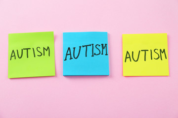 Stickers with word AUTISM on color background