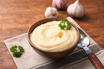 Bowl with mashed potatoes on table