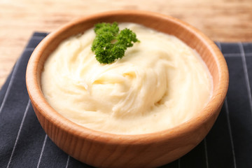 Bowl with mashed potatoes on table