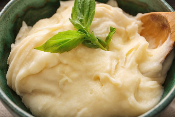 Mashed potatoes and spoon in bowl, closeup