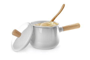 Cookware with mashed potatoes and spoon on white background